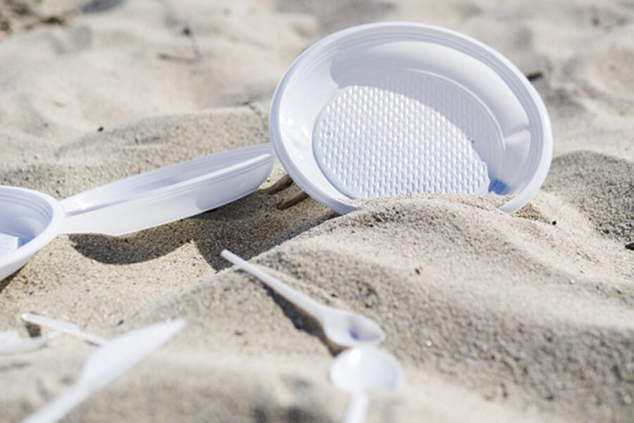 plastic-plate-and-spoon-on-beach-sand-625418f7c06b9166426069