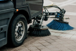 sweeper is sweeping asphalt. Cleaning the path with a cleaning vehicle