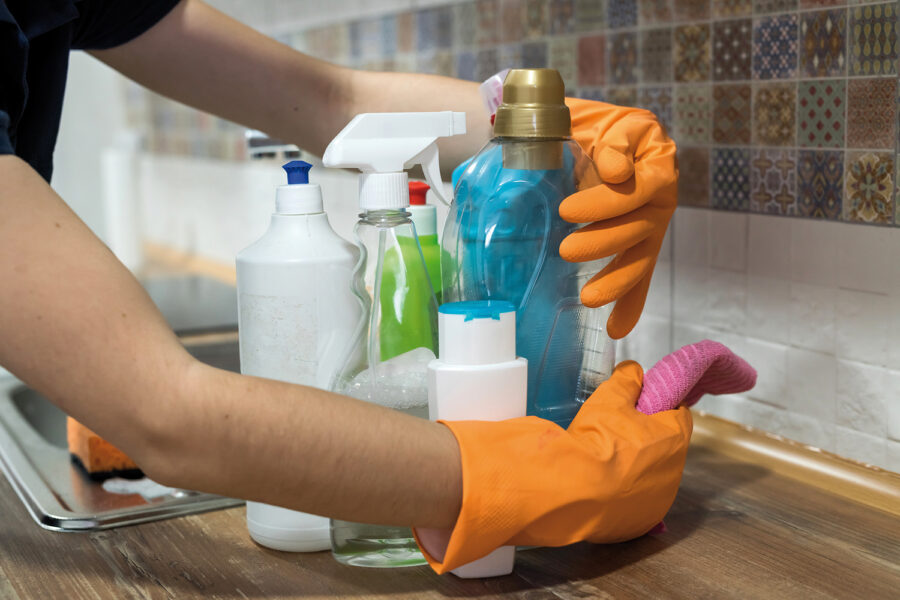 woman holding cleaning products and products and ready to clean. housework